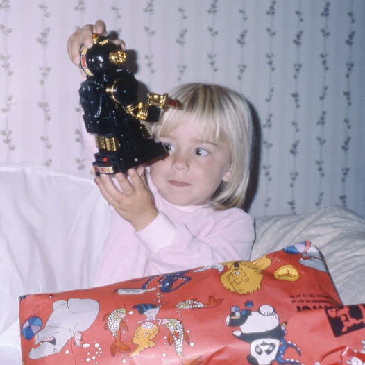 Alexandra as a child holding a robot